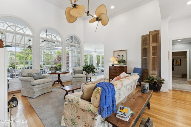 8300 Fazio Dr, Wilmington, NC 28411 - living room featuring ornamental molding, a ceiling fan, light wood-style floors, a towering ceiling, and recessed lighting