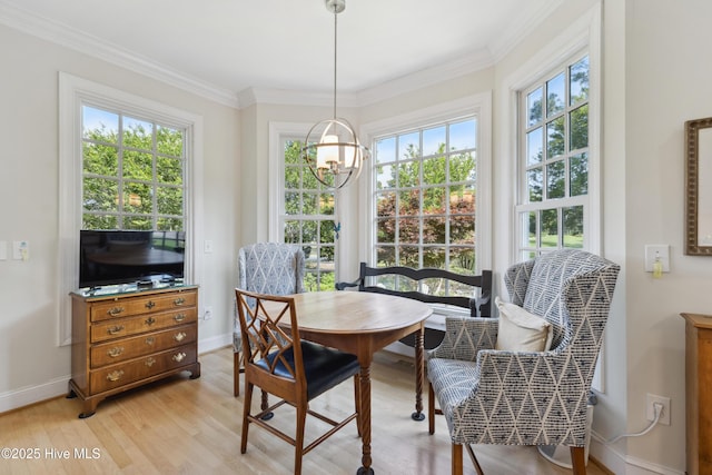 8300 Fazio Dr, Wilmington, NC 28411 - dining room featuring a chandelier, light wood-type flooring, ornamental molding, and baseboards