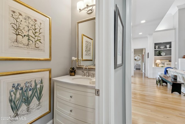 8300 Fazio Dr, Wilmington, NC 28411 - bathroom featuring vanity, wood finished floors, built in shelves, and recessed lighting