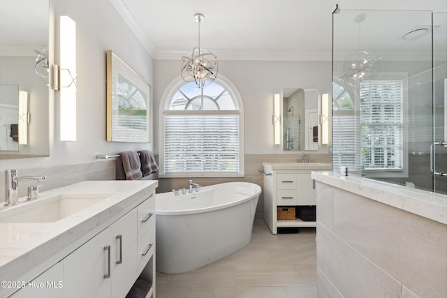 8300 Fazio Dr, Wilmington, NC 28411 - bathroom featuring two vanities, tile patterned flooring, a soaking tub, a stall shower, and ornamental molding