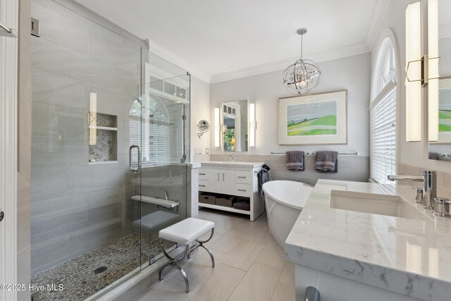 8300 Fazio Dr, Wilmington, NC 28411 - bathroom featuring a stall shower, ornamental molding, vanity, a chandelier, and a freestanding tub