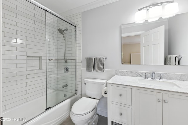 8300 Fazio Dr, Wilmington, NC 28411 - bathroom featuring toilet, vanity, enclosed tub / shower combo, wainscoting, and crown molding