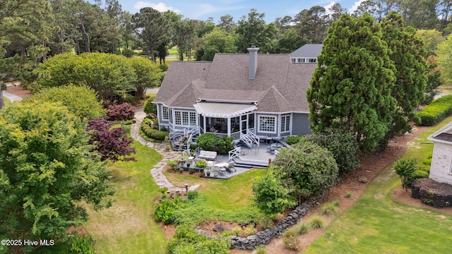 8300 Fazio Dr, Wilmington, NC 28411 - back of house featuring a chimney, a yard, view of scattered trees, a patio, and stairs