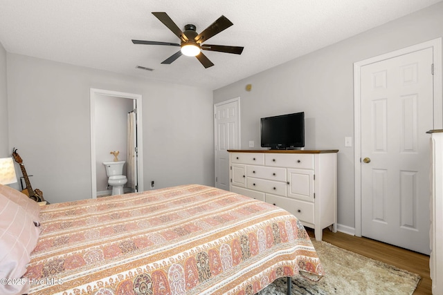 7321 Haskell Ct, Wilmington, NC 28411 - bedroom featuring wood finished floors, connected bathroom, and a ceiling fan
