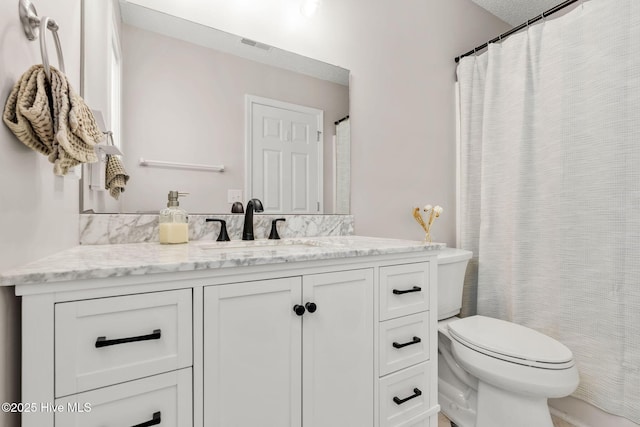 7321 Haskell Ct, Wilmington, NC 28411 - bathroom with toilet, vanity, and curtained shower