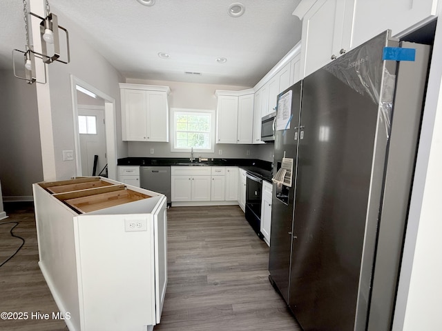 158 Texas Rd, Shiloh, NC 27974 - kitchen featuring stainless steel appliances, a sink, white cabinetry, wood finished floors, and recessed lighting