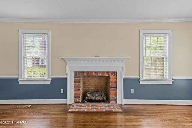 1510 Lucerne Way, New Bern, NC 28560 - unfurnished living room featuring crown molding, wood finished floors, healthy amount of natural light, and baseboards
