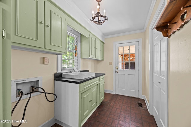 1510 Lucerne Way, New Bern, NC 28560 - washroom featuring cabinet space, washer hookup, brick patterned floors, a chandelier, and crown molding