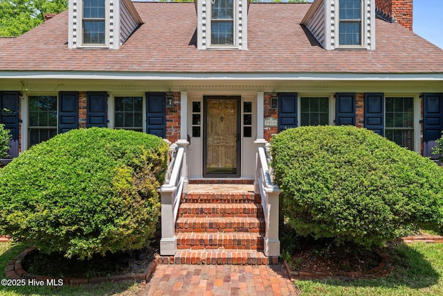 1510 Lucerne Way, New Bern, NC 28560 - view of exterior entry with a chimney and roof with shingles