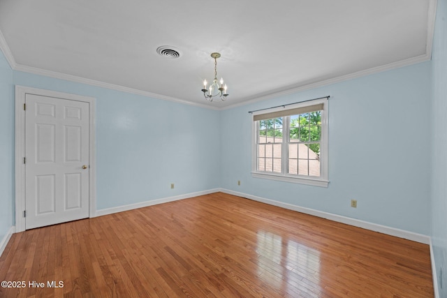 1510 Lucerne Way, New Bern, NC 28560 - unfurnished room with a chandelier, hardwood / wood-style flooring, crown molding, and baseboards