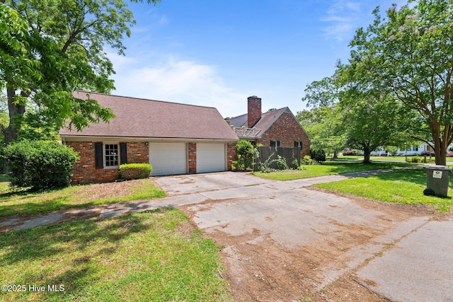 1510 Lucerne Way, New Bern, NC 28560 - view of front of property featuring brick siding, a garage, driveway, and a chimney