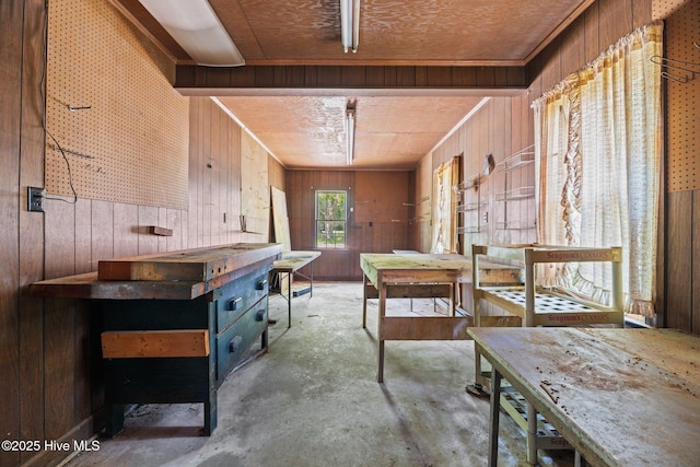 1510 Lucerne Way, New Bern, NC 28560 - misc room featuring wood walls, a workshop area, and unfinished concrete flooring
