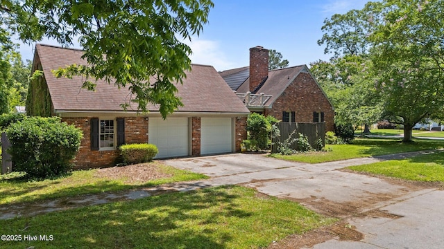 1510 Lucerne Way, New Bern, NC 28560 - view of front of property with an attached garage, brick siding, concrete driveway, a front yard, and a chimney