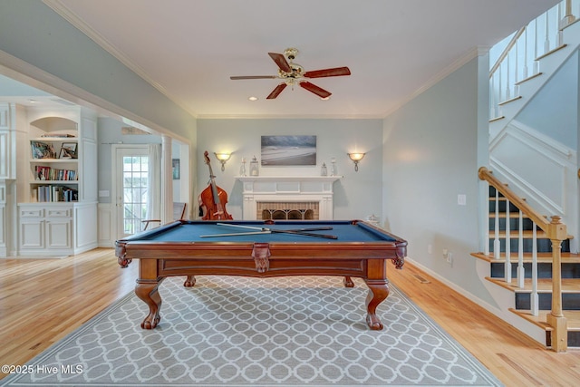 809 Berwyn Rd, Wilmington, NC 28409 - playroom with wood finished floors, billiards, ornamental molding, a ceiling fan, and a brick fireplace