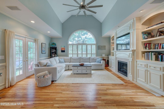 809 Berwyn Rd, Wilmington, NC 28409 - living area with a ceiling fan, a fireplace, light wood-style floors, french doors, and high vaulted ceiling