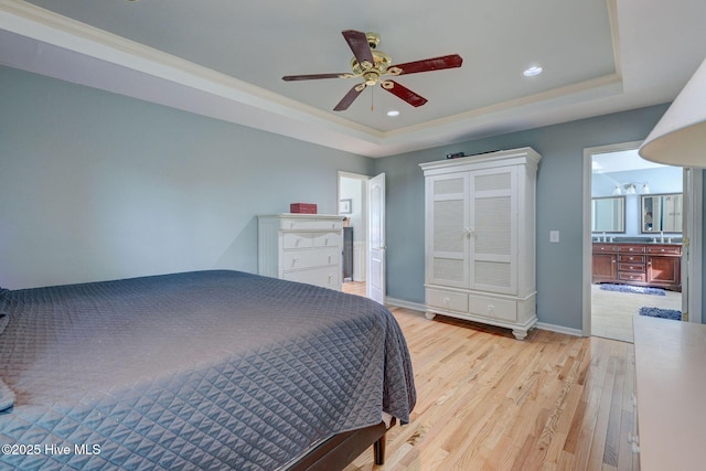 809 Berwyn Rd, Wilmington, NC 28409 - bedroom featuring a tray ceiling, light wood-style floors, recessed lighting, ensuite bath, and baseboards