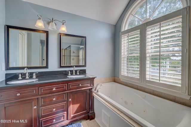 809 Berwyn Rd, Wilmington, NC 28409 - bathroom with lofted ceiling, double vanity, a whirlpool tub, a stall shower, and tile patterned floors