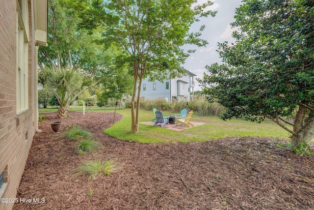 809 Berwyn Rd, Wilmington, NC 28409 - view of grassy yard featuring a patio and an outdoor fire pit