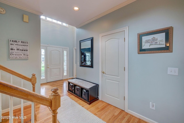 809 Berwyn Rd, Wilmington, NC 28409 - foyer entrance with light wood-type flooring, crown molding, recessed lighting, baseboards, and stairway