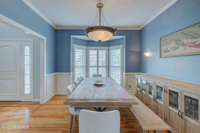 809 Berwyn Rd, Wilmington, NC 28409 - dining room featuring wainscoting, light wood-type flooring, crown molding, and a decorative wall