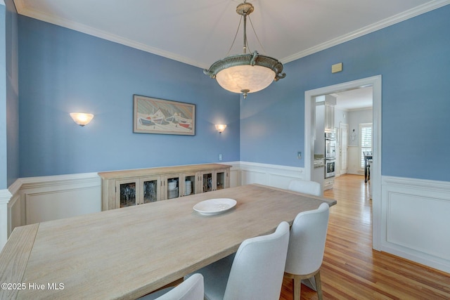 809 Berwyn Rd, Wilmington, NC 28409 - dining room featuring wainscoting, wood finished floors, ornamental molding, and a decorative wall