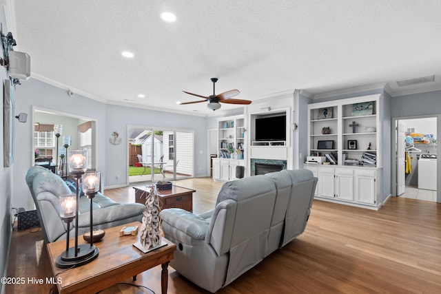 1434 Wagon Ct, Wilmington, NC 28412 - living area featuring light wood-type flooring, ceiling fan, crown molding, a textured ceiling, and a fireplace