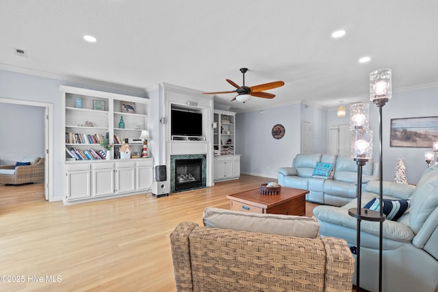 1434 Wagon Ct, Wilmington, NC 28412 - living area featuring crown molding, a ceiling fan, light wood-style flooring, a premium fireplace, and baseboards