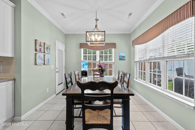 1434 Wagon Ct, Wilmington, NC 28412 - dining area with a chandelier, light tile patterned flooring, ornamental molding, and baseboards