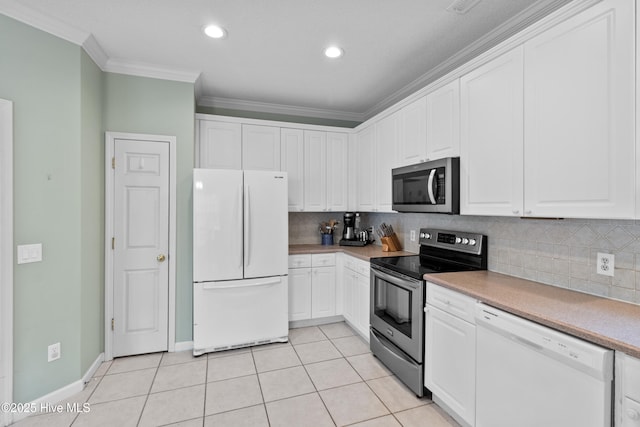 1434 Wagon Ct, Wilmington, NC 28412 - kitchen featuring appliances with stainless steel finishes, ornamental molding, backsplash, white cabinetry, and light tile patterned floors