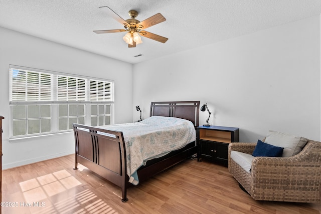 1434 Wagon Ct, Wilmington, NC 28412 - bedroom with wood finished floors, a textured ceiling, and a ceiling fan
