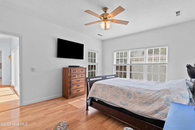 1434 Wagon Ct, Wilmington, NC 28412 - bedroom featuring wood finished floors, baseboards, a ceiling fan, and a textured ceiling