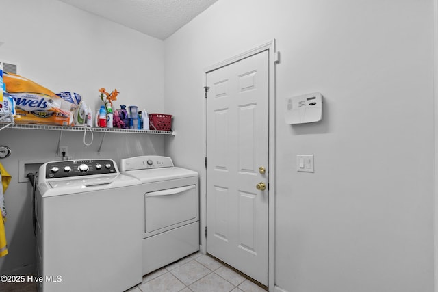 1434 Wagon Ct, Wilmington, NC 28412 - laundry room with washing machine and clothes dryer, light tile patterned floors, and a textured ceiling