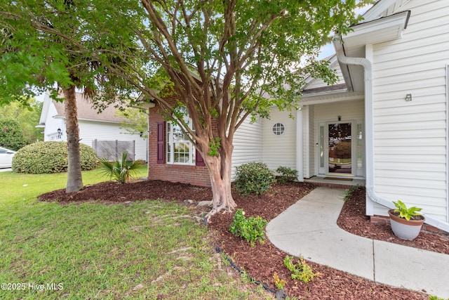 1434 Wagon Ct, Wilmington, NC 28412 - doorway to property featuring a yard and brick siding