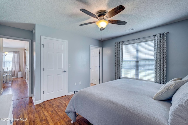 443 Foxfield Ct, Wilmington, NC 28411 - bedroom with wood finished floors, a textured ceiling, ceiling fan, baseboards, and a chandelier