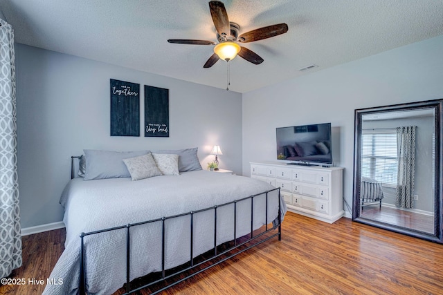 443 Foxfield Ct, Wilmington, NC 28411 - bedroom with wood finished floors, baseboards, a textured ceiling, and a ceiling fan