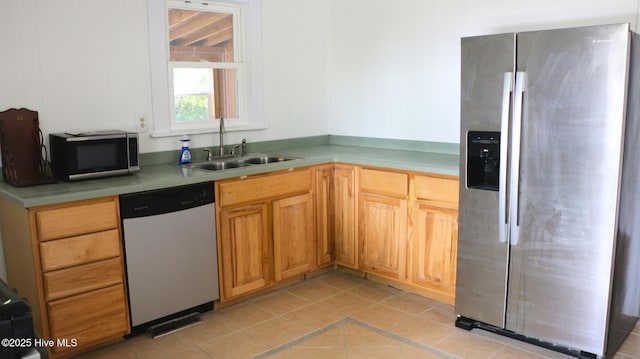 1817 Asheville St, New Bern, NC 28560 - kitchen featuring appliances with stainless steel finishes, a sink, light countertops, and light tile patterned flooring