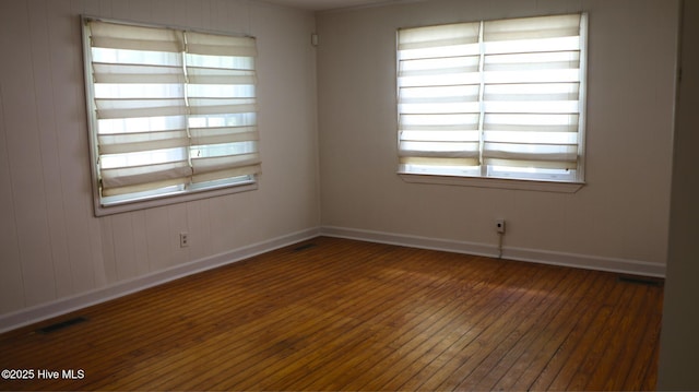 1817 Asheville St, New Bern, NC 28560 - unfurnished room featuring wood-type flooring, healthy amount of natural light, and baseboards