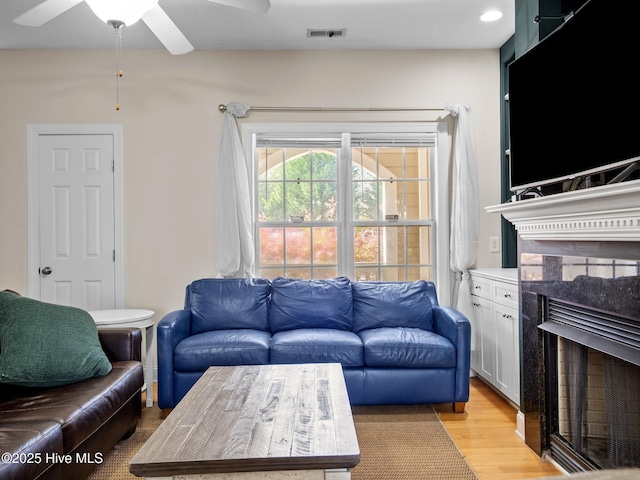98 Mccain Ln Unit 3, Swansboro, NC 28584 - living room with a fireplace, ceiling fan, light wood finished floors, and recessed lighting