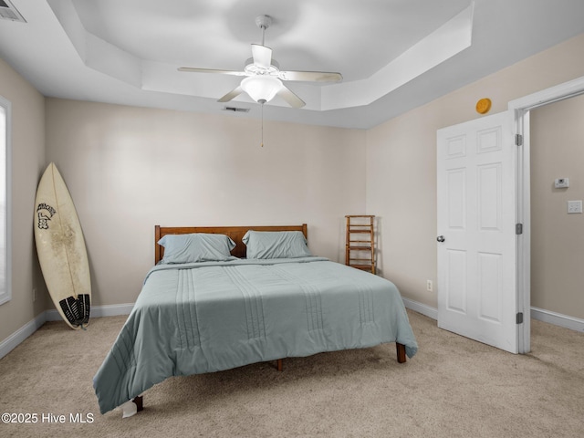 98 Mccain Ln Unit 3, Swansboro, NC 28584 - carpeted bedroom with a tray ceiling, baseboards, and a ceiling fan