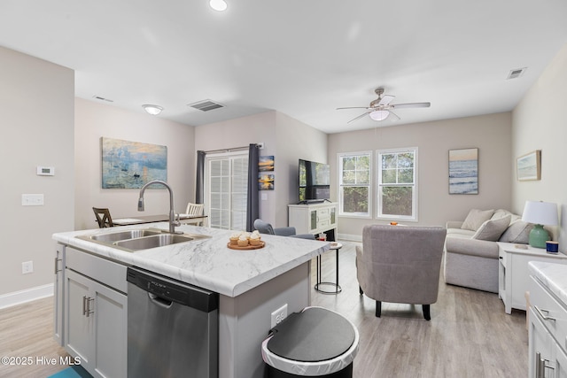 210 N Stingray Ln, Sneads Ferry, NC 28460 - kitchen featuring dishwasher, a sink, light wood-style floors, and open floor plan