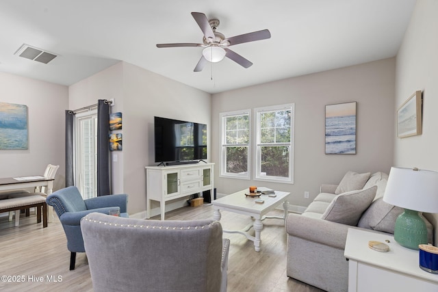 210 N Stingray Ln, Sneads Ferry, NC 28460 - living area featuring light wood-style flooring, a ceiling fan, and baseboards