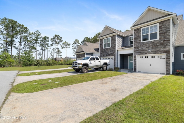 210 N Stingray Ln, Sneads Ferry, NC 28460 - view of front of property featuring stone siding, board and batten siding, driveway, and a front yard
