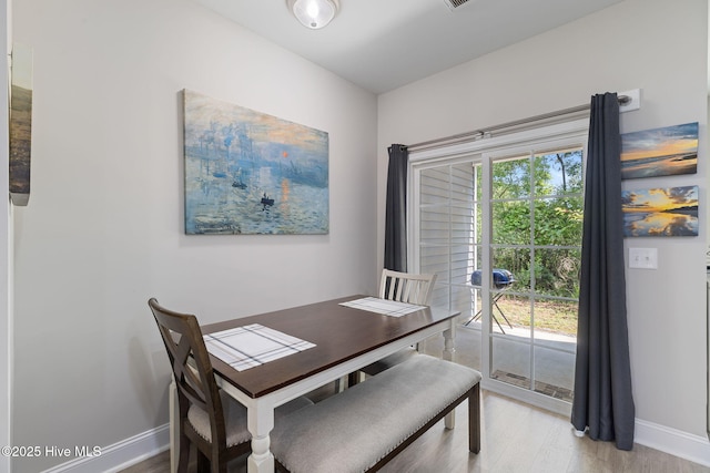 210 N Stingray Ln, Sneads Ferry, NC 28460 - dining room with light wood-style flooring and baseboards
