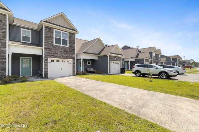 210 N Stingray Ln, Sneads Ferry, NC 28460 - townhome / multi-family property with board and batten siding, stone siding, concrete driveway, a front lawn, and a residential view