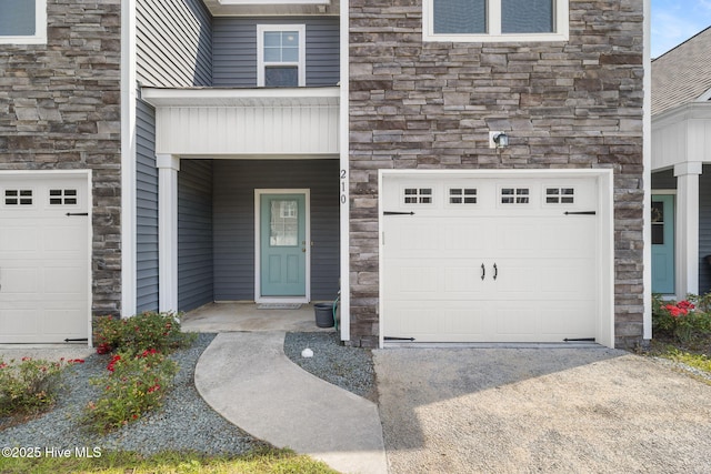 210 N Stingray Ln, Sneads Ferry, NC 28460 - property entrance with stone siding, an attached garage, and concrete driveway