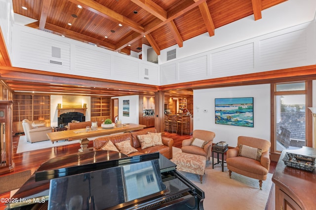 218 Row Boat Row, Bald Head Island, NC 28461 - living area featuring wood ceiling with exposed beams, a towering ceiling, built in shelves, and a fireplace
