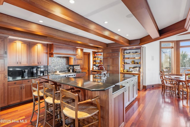 218 Row Boat Row, Bald Head Island, NC 28461 - kitchen featuring beamed ceiling, backsplash, baseboards, light wood-style floors, and open shelves