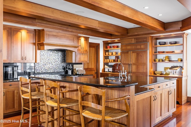 218 Row Boat Row, Bald Head Island, NC 28461 - kitchen featuring open shelves, a sink, dark wood-style flooring, backsplash, and beamed ceiling