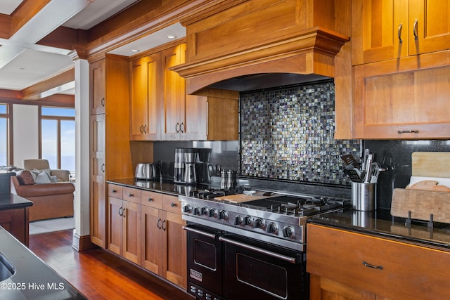 218 Row Boat Row, Bald Head Island, NC 28461 - kitchen with range with two ovens, decorative backsplash, dark wood finished floors, brown cabinetry, and coffered ceiling