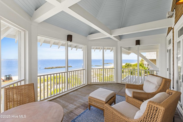 218 Row Boat Row, Bald Head Island, NC 28461 - sunroom featuring view of water and beach, wood-type flooring, and healthy amount of natural light